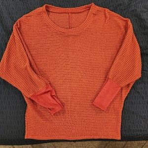 Waffle knit orange top.